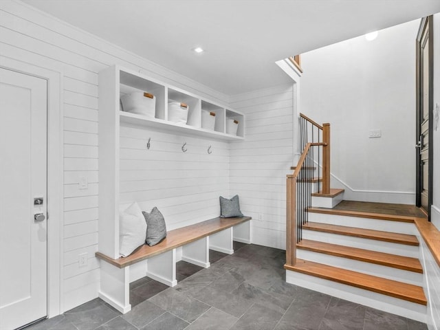 mudroom with wooden walls
