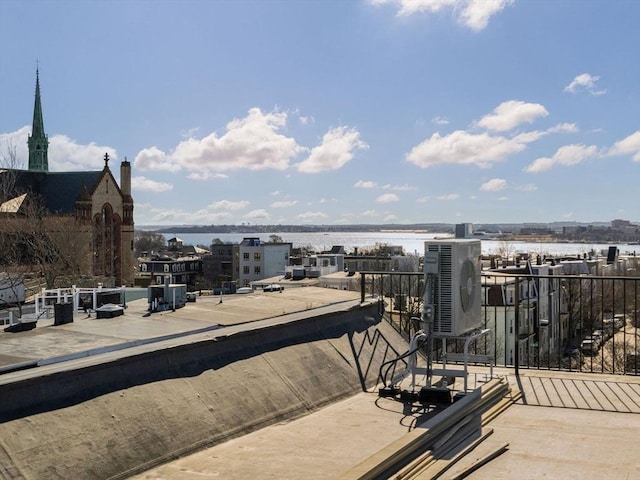 view of patio featuring a water view and ac unit