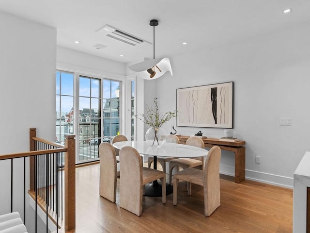 dining space with light wood-style floors, baseboards, and recessed lighting