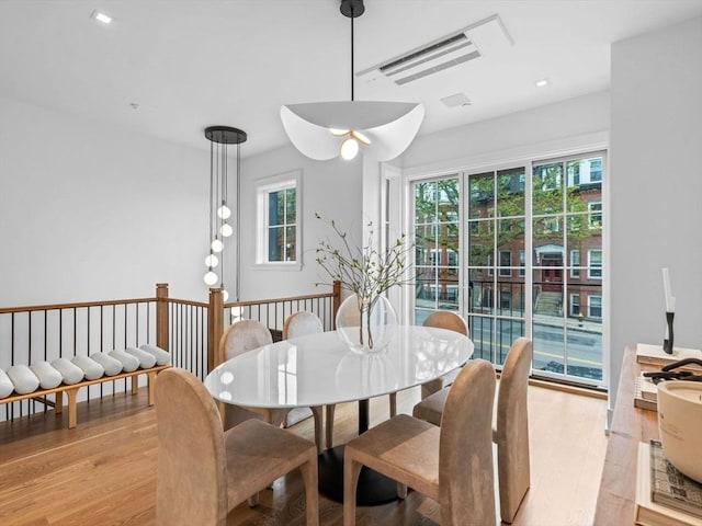 dining space with plenty of natural light, light wood finished floors, and recessed lighting