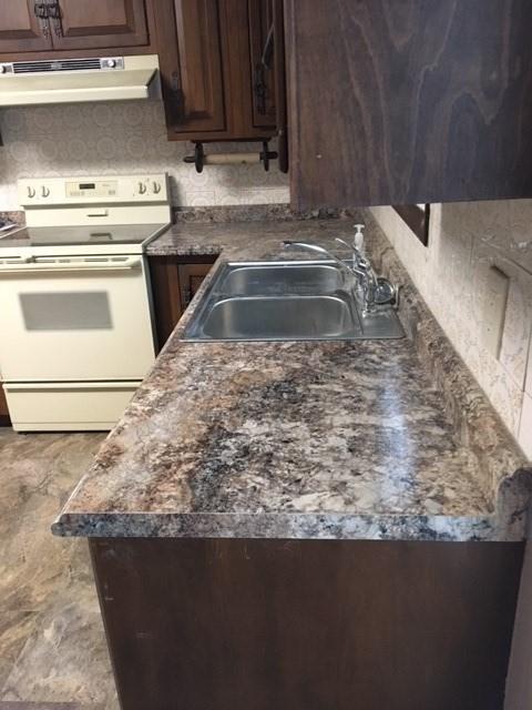 58 Jay St, North Attleboro, MA 02760 - kitchen featuring electric range, a sink, exhaust hood, dark countertops, and dark brown cabinetry