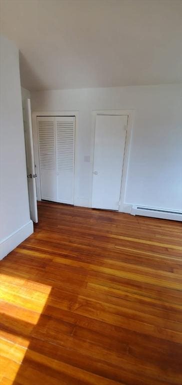 58 Jay St, North Attleboro, MA 02760 - unfurnished bedroom featuring baseboard heating, wood finished floors, a closet, and baseboards