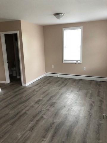 58 Jay St, North Attleboro, MA 02760 - unfurnished room with a baseboard radiator, baseboards, and dark wood-style floors