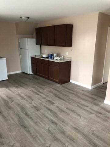 58 Jay St, North Attleboro, MA 02760 - kitchen featuring freestanding refrigerator, baseboards, light wood finished floors, and dark brown cabinetry