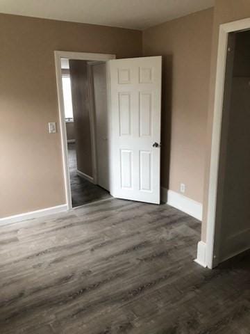 58 Jay St, North Attleboro, MA 02760 - unfurnished bedroom with dark wood-type flooring, baseboards, and a closet