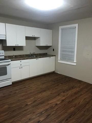 58 Jay St, North Attleboro, MA 02760 - kitchen with white range with electric cooktop, range hood, dark wood-style floors, and white cabinets