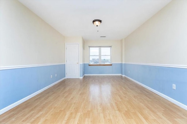 empty room with wood finished floors and baseboards