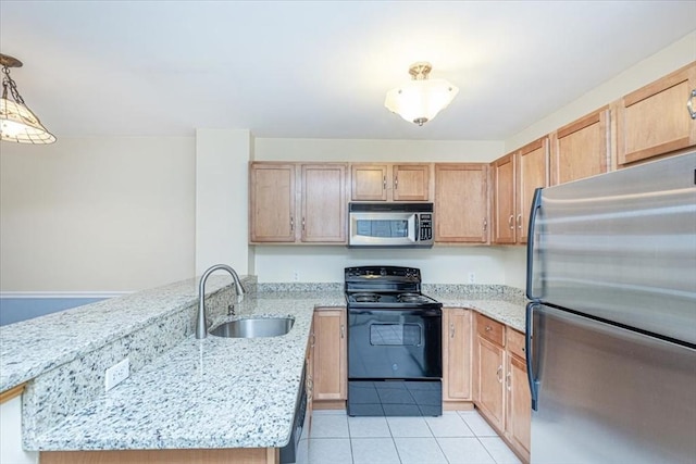 kitchen featuring appliances with stainless steel finishes, a sink, a peninsula, light tile patterned flooring, and light stone countertops