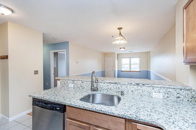 kitchen with dishwasher, a sink, light tile patterned floors, baseboards, and light stone countertops