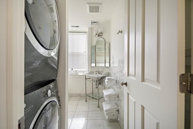 337 Marlborough Unit 3, Boston, MA 02115 - bathroom featuring stacked washer and clothes dryer, tile patterned flooring, and a sink