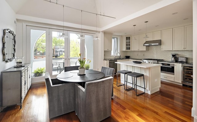 337 Marlborough Unit 3, Boston, MA 02115 - kitchen with under cabinet range hood, beverage cooler, oven, dishwasher, and plenty of natural light