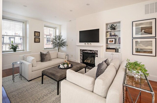 337 Marlborough Unit 3, Boston, MA 02115 - living area featuring baseboards, wood finished floors, a premium fireplace, and built in shelves
