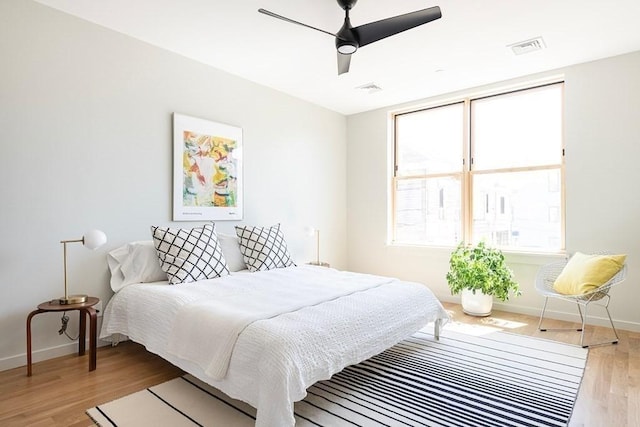 bedroom with ceiling fan and light wood-type flooring