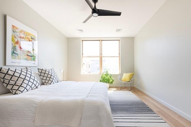 bedroom with light hardwood / wood-style floors and ceiling fan