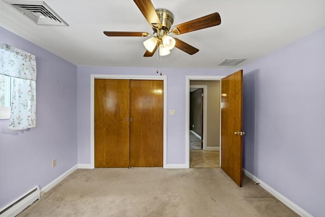 unfurnished bedroom with light carpet, a baseboard radiator, visible vents, and baseboards