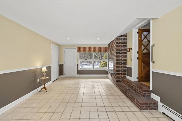 entrance foyer featuring light tile patterned floors, baseboard heating, and baseboards