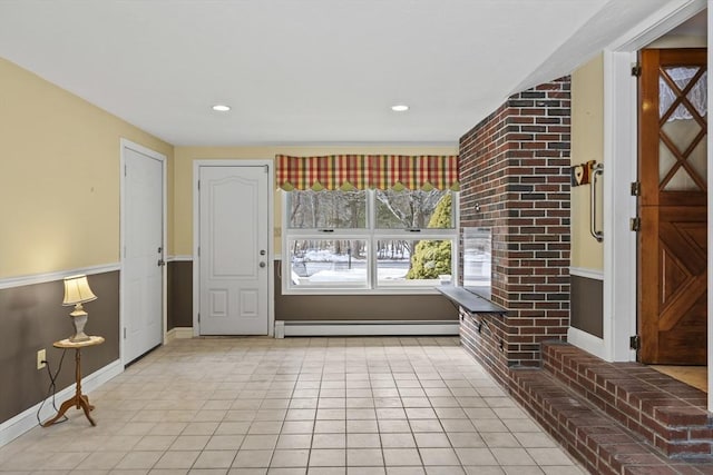 foyer featuring a baseboard heating unit, recessed lighting, light tile patterned flooring, and baseboards