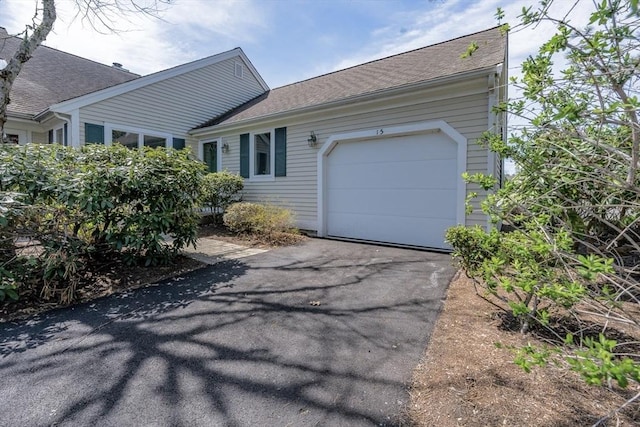 single story home featuring driveway and a garage