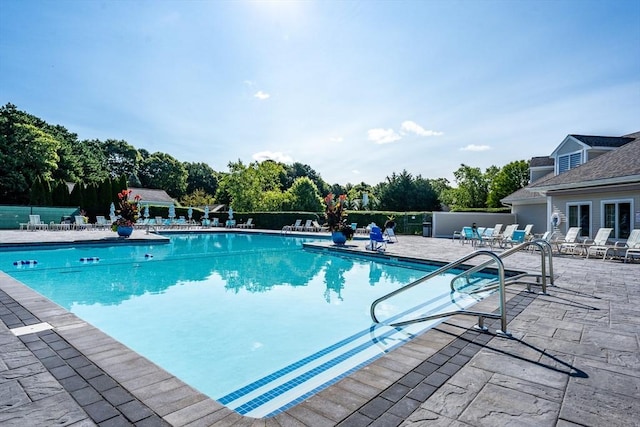 pool featuring fence and a patio area