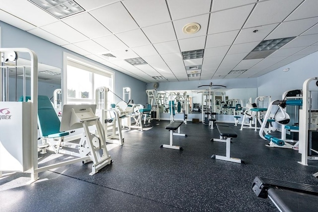 exercise room with a paneled ceiling