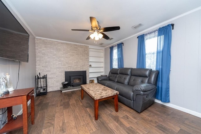 13 Westgate Rd, Framingham, MA 01701 - living area with wood finished floors, a ceiling fan, ornamental molding, a wood stove, and built in features