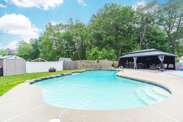13 Westgate Rd, Framingham, MA 01701 - view of pool featuring a gazebo, a patio area, a fenced backyard, a storage unit, and view of scattered trees