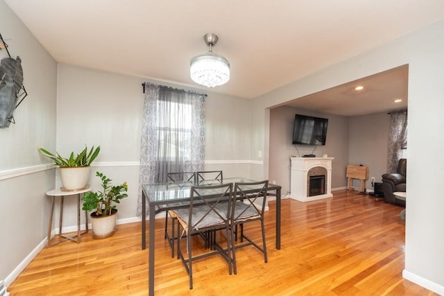 13 Westgate Rd, Framingham, MA 01701 - dining room featuring wood finished floors, a fireplace with raised hearth, recessed lighting, and a chandelier