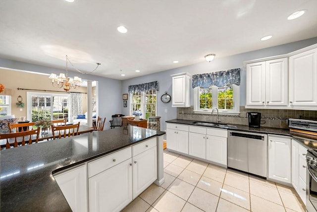 304 Godfrey Dr Unit 304, Norton, MA 02766 - kitchen with appliances with stainless steel finishes, a sink, light tile patterned floors, tasteful backsplash, and white cabinets