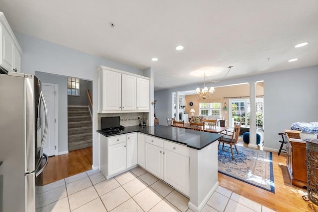 304 Godfrey Dr Unit 304, Norton, MA 02766 - kitchen featuring freestanding refrigerator, dark countertops, white cabinetry, a peninsula, and recessed lighting