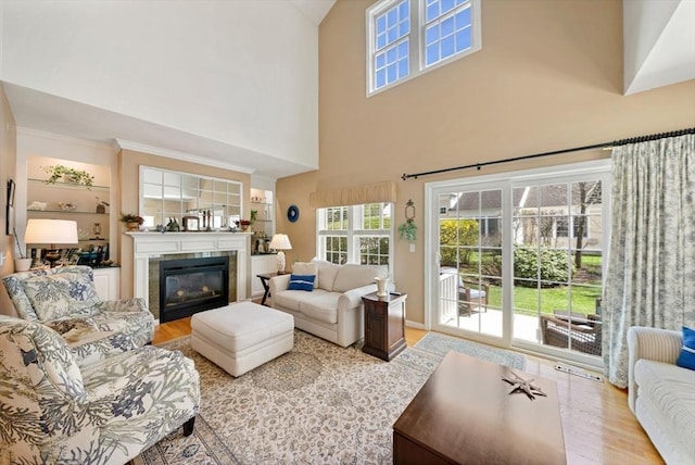 304 Godfrey Dr Unit 304, Norton, MA 02766 - living room featuring wood finished floors, a tiled fireplace, and a high ceiling