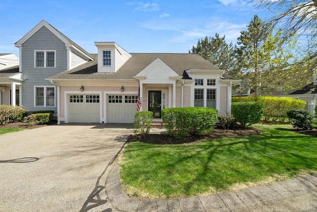 304 Godfrey Dr Unit 304, Norton, MA 02766 - view of front facade featuring a garage, driveway, a front yard, and roof with shingles