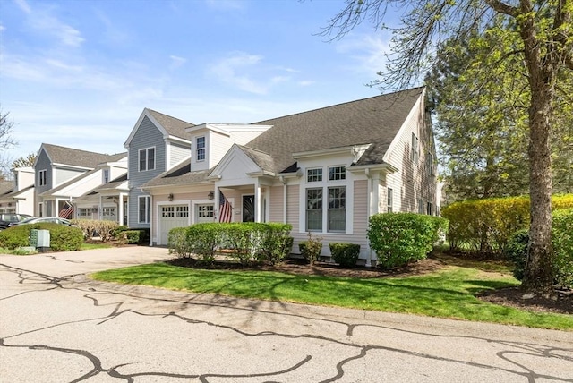 304 Godfrey Dr Unit 304, Norton, MA 02766 - view of front of home with concrete driveway, a shingled roof, and an attached garage