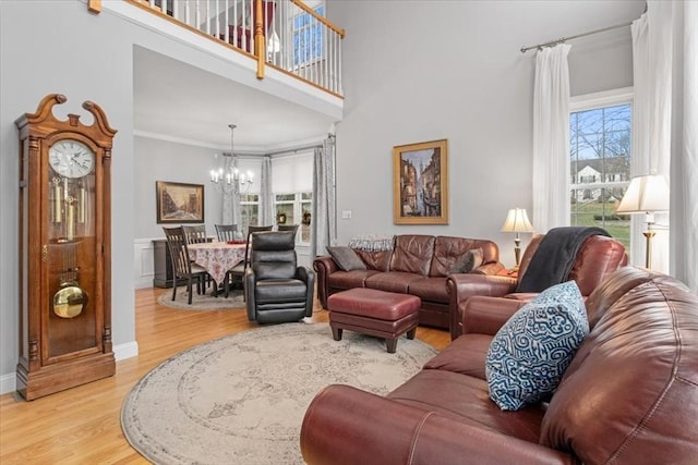 4 Rose Court Way Unit 4, Walpole, MA 02032 - living room featuring a chandelier, light wood finished floors, crown molding, baseboards, and a high ceiling