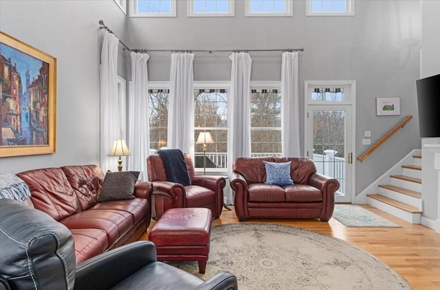 4 Rose Court Way Unit 4, Walpole, MA 02032 - living room with a high ceiling, wood finished floors, stairs, and baseboards