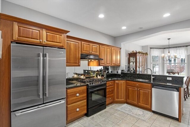 4 Rose Court Way Unit 4, Walpole, MA 02032 - kitchen with stainless steel appliances, a sink, brown cabinets, under cabinet range hood, and a peninsula