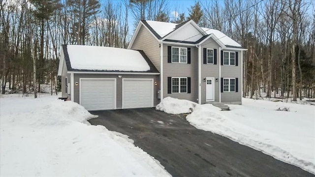 colonial house with a garage and driveway