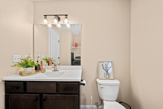 half bathroom with vanity and toilet