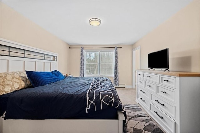 bedroom featuring light carpet and baseboards