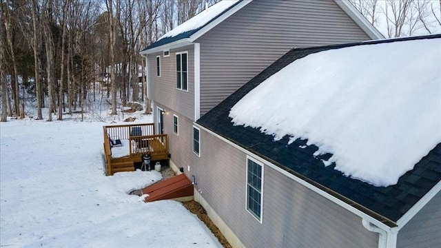 view of snowy exterior with a wooden deck