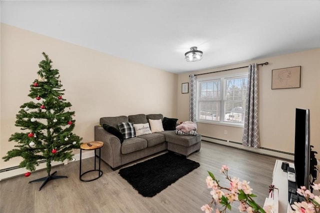 living area featuring baseboard heating and wood finished floors