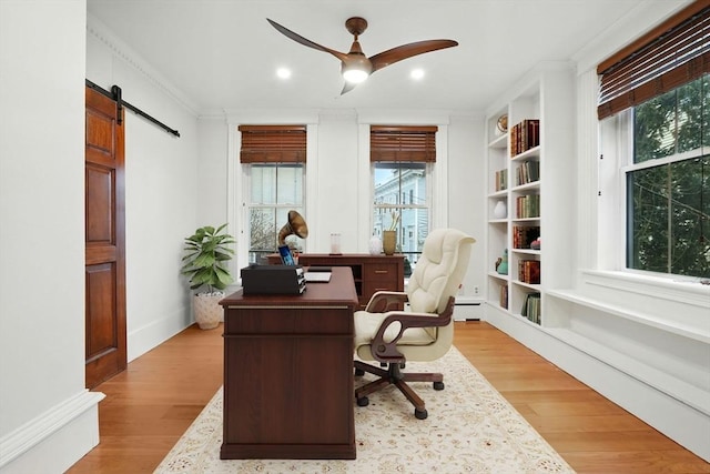 office area with a ceiling fan, a barn door, recessed lighting, and light wood finished floors