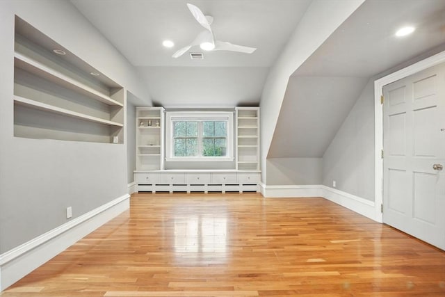 bonus room with baseboards, vaulted ceiling, visible vents, a baseboard radiator, and wood finished floors