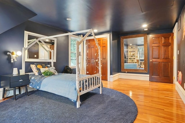 bedroom with baseboards, recessed lighting, and wood finished floors