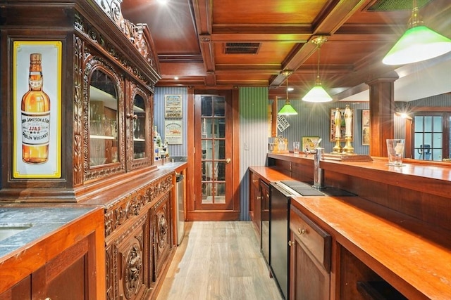 bar with visible vents, decorative light fixtures, a bar, light wood-style floors, and wood ceiling