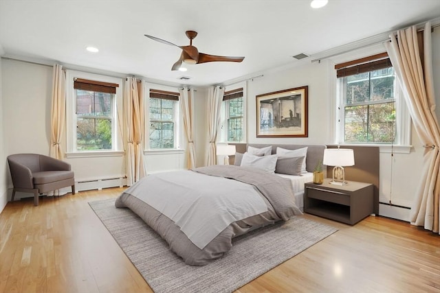 bedroom featuring recessed lighting, light wood-type flooring, and multiple windows