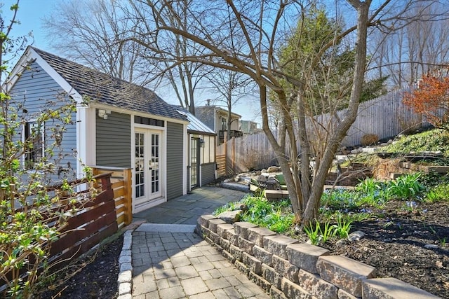 exterior space with a patio, french doors, and fence