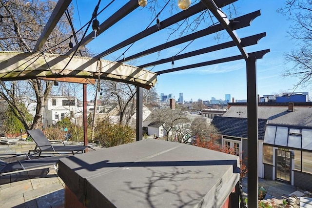 view of patio featuring a city view and a pergola