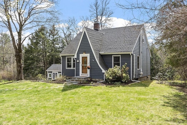 a-frame home featuring roof with shingles, a chimney, and a front yard