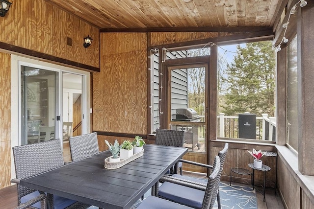 sunroom / solarium featuring plenty of natural light and outdoor dining space