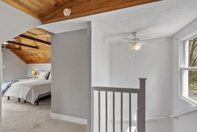 carpeted bedroom with baseboards, a ceiling fan, lofted ceiling, and wooden ceiling